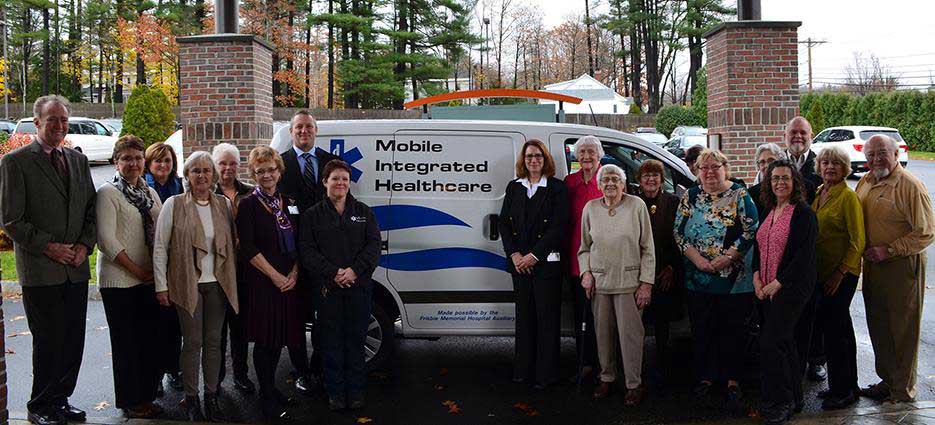 Frisbie Memorial Hospital Auxiliary members standing in front of van