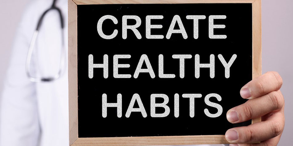 A doctor holds a sign that says Create healthy habits