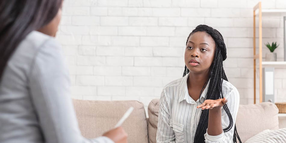 A woman meets with a therapist.