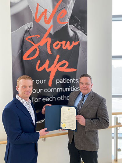 Mayor Paul Callaghan presenting the award to Dr. Trevor Elde, Chief Medical Officer